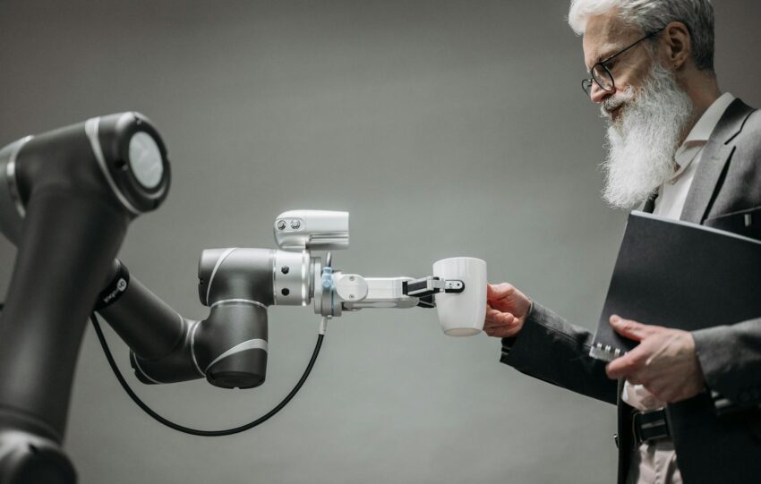 An image of a man with robot handing him a glass of water