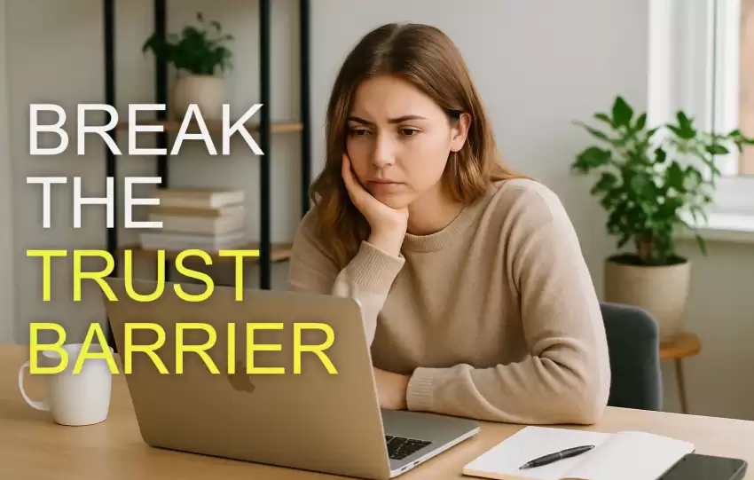 a young Caucasian female small business owner sitting at a desk in a bright home office, looking at her laptop screen with a thoughtful, slightly concerned expression