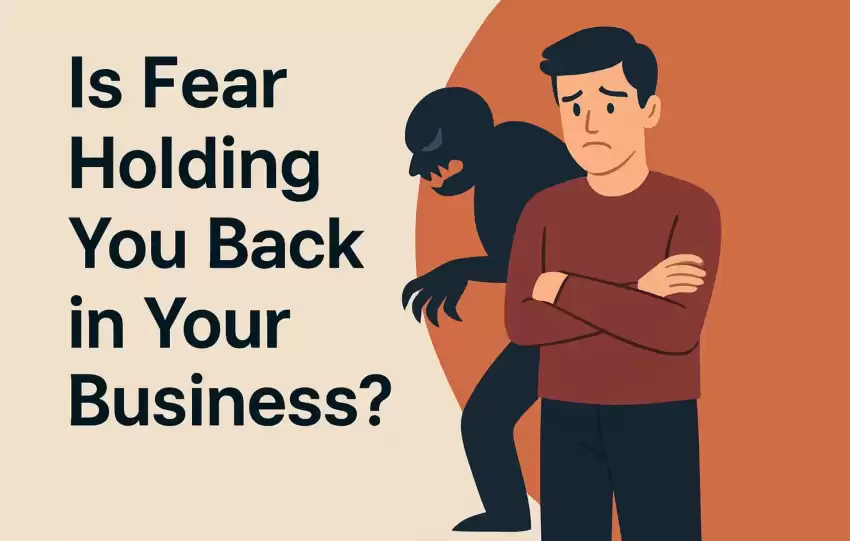 Concerned entrepreneur standing with arms crossed while a dark shadow representing fear looms behind him, illustrating fear holding you back in your business.