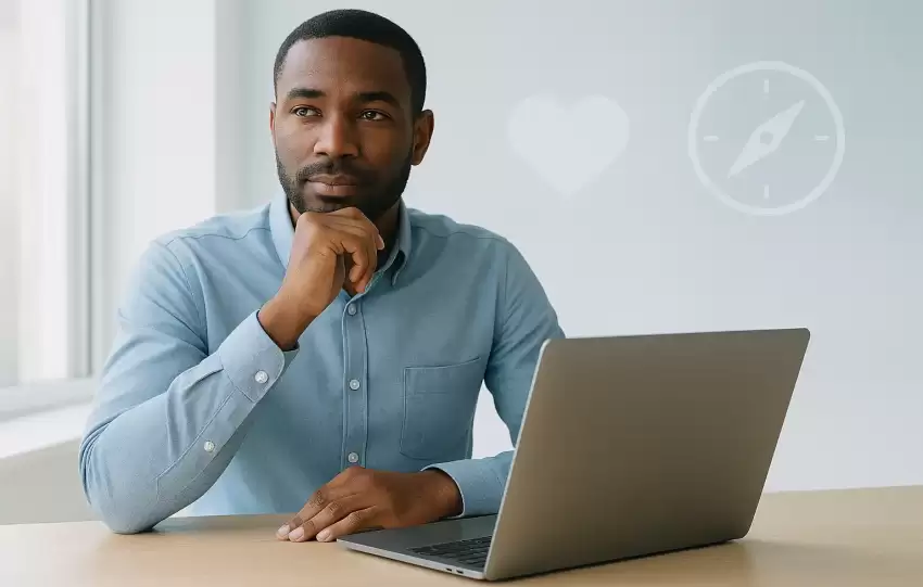 Entrepreneur sitting at desk with laptop and soft digital icons representing discernment, empathy, and timing — the 3 quiet skills vital for online success in 2025.